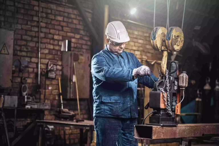 focused-worker-is-using-small-mobile-drill-make-holes-part-rail