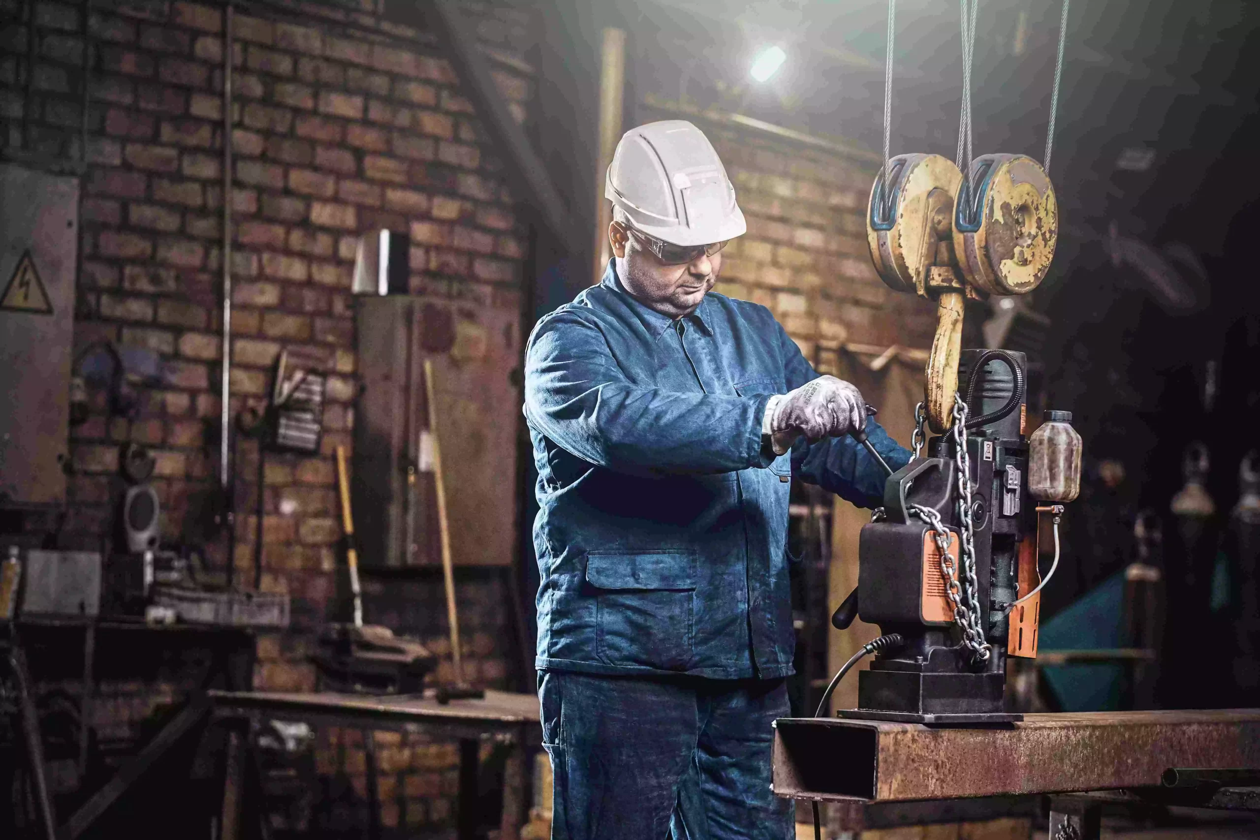 focused-worker-is-using-small-mobile-drill-make-holes-part-rail